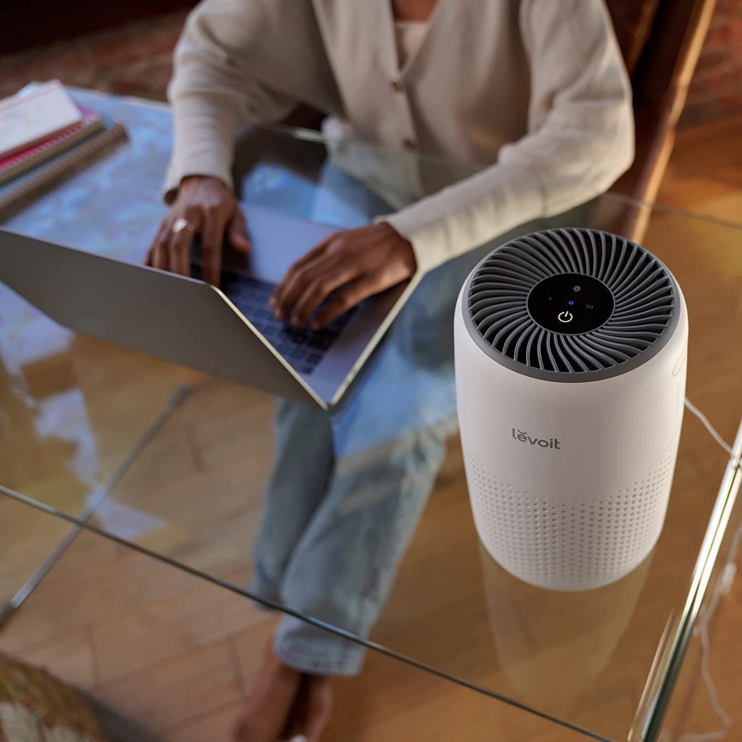 Levoit Core Mini air purifier on desk in an office setting, improving air quality