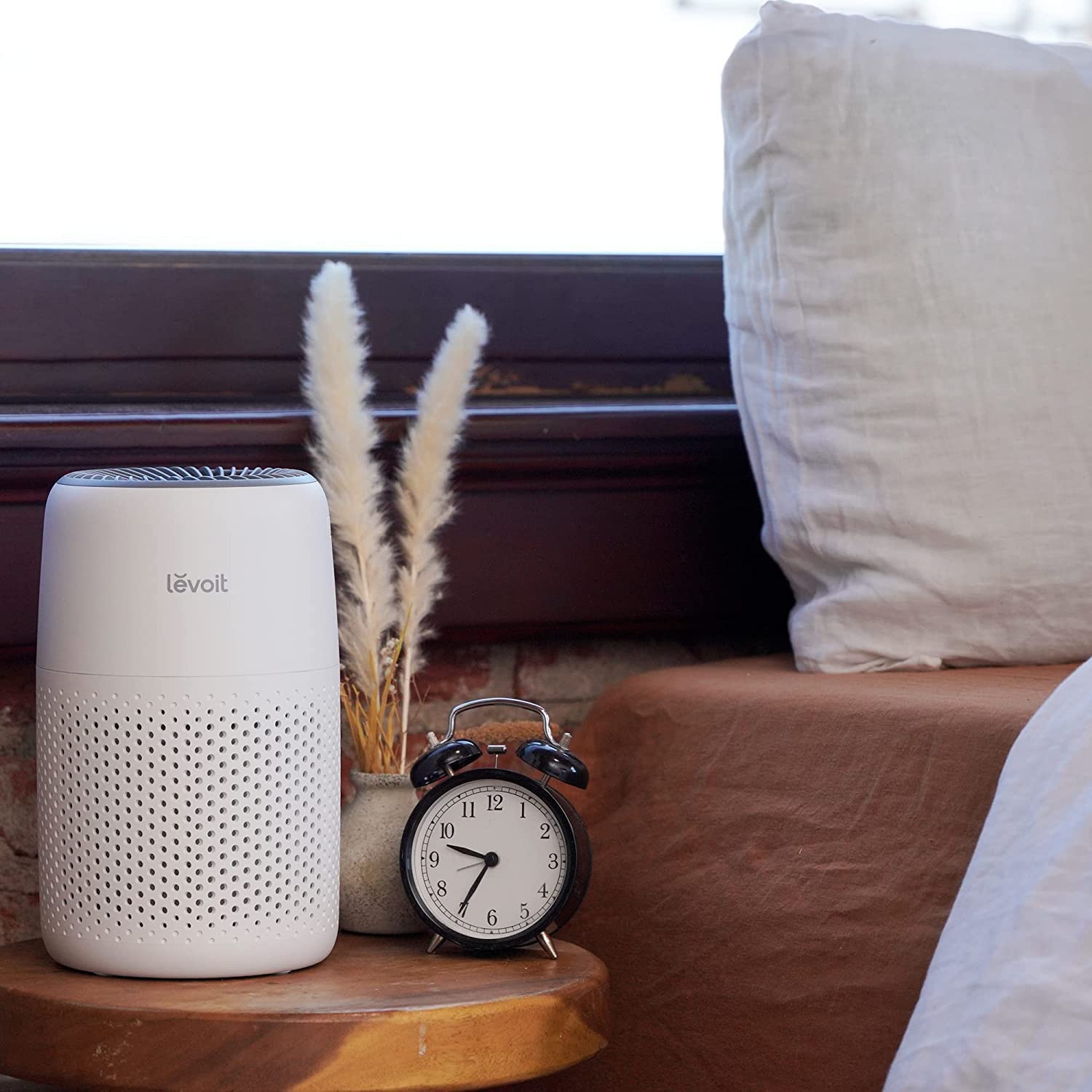 Levoit Core Mini air purifier on bedside table, ideal for bedroom use to improve air quality and ensure a restful night’s sleep.