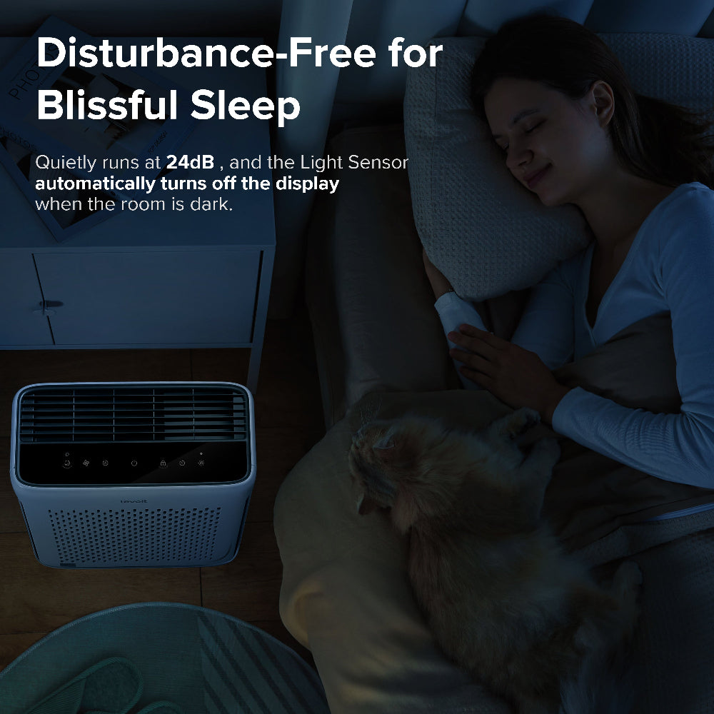 Levoit Vital 100S true HEPA air purifier with carbon filter, 24dB quiet operation with light sensor display off, woman sleeping with cat