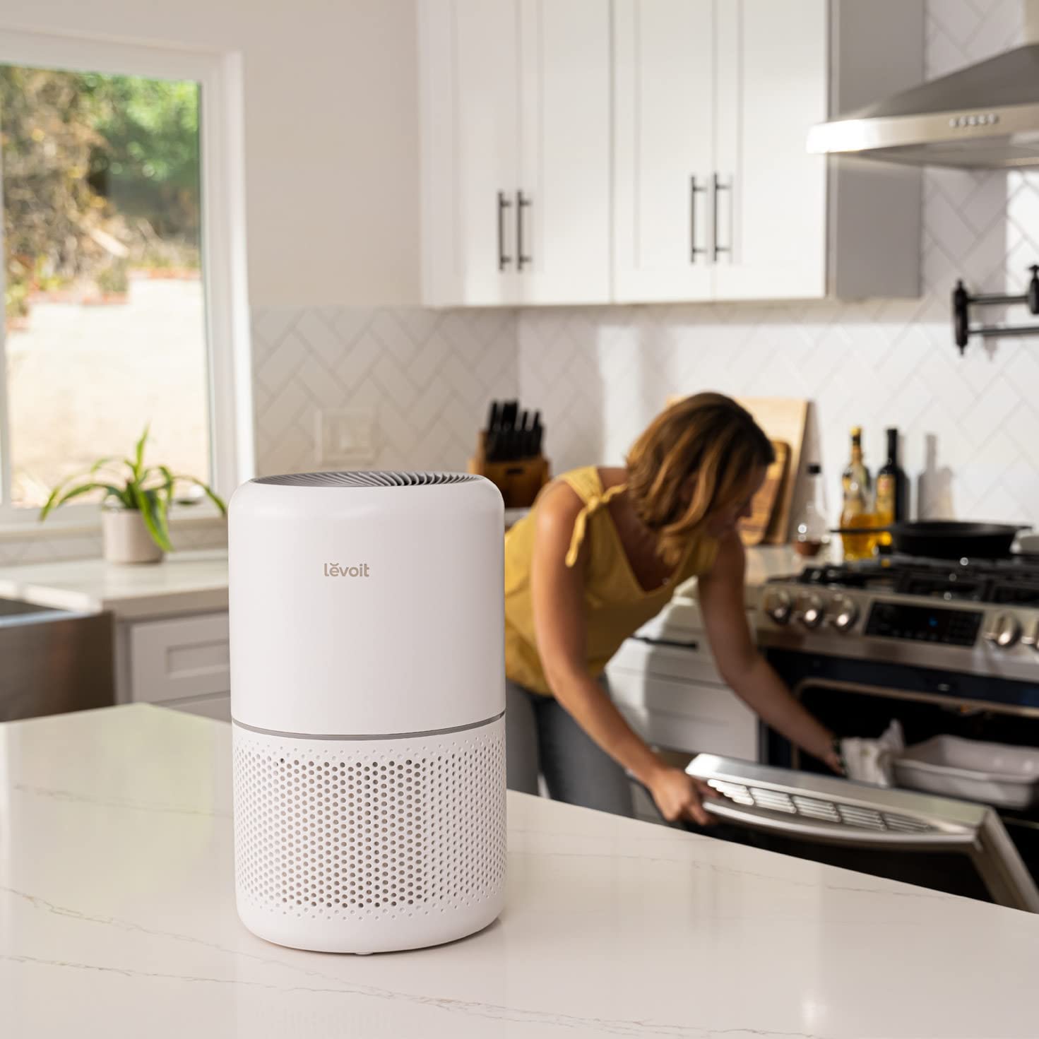 Levoit Core 300 Air Purifier placed on a kitchen counter, ensuring clean air and promoting a fresh cooking environment.